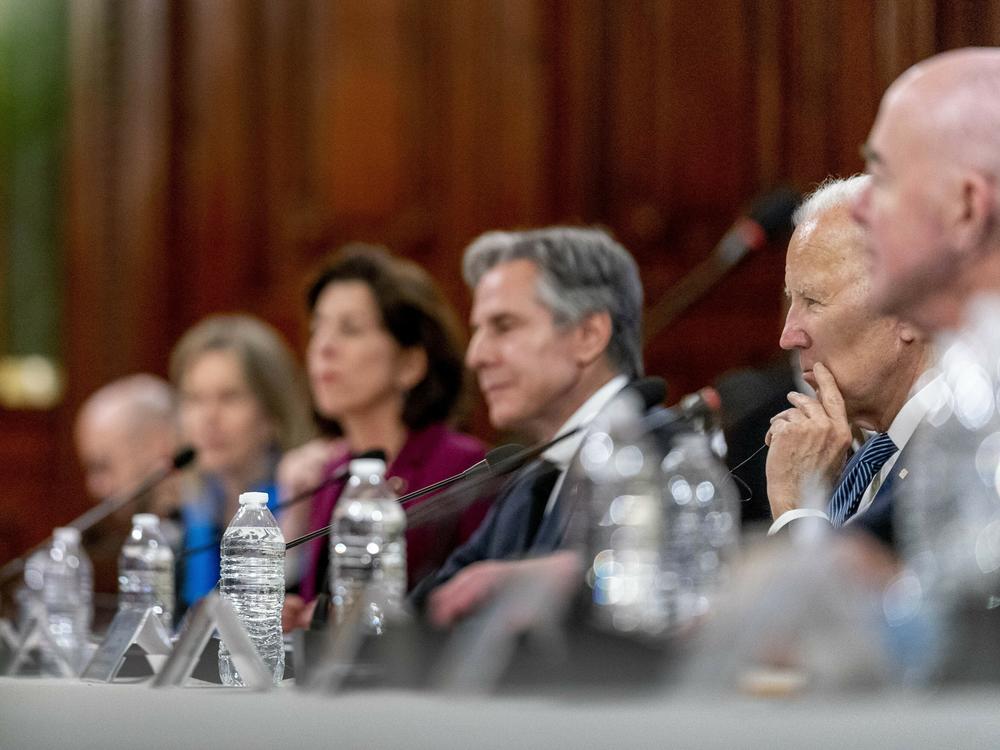 President Biden and members of his cabinet listen as Mexican President Andrés Manuel López Obrador speaks during a meeting at the National Palace in Mexico City.