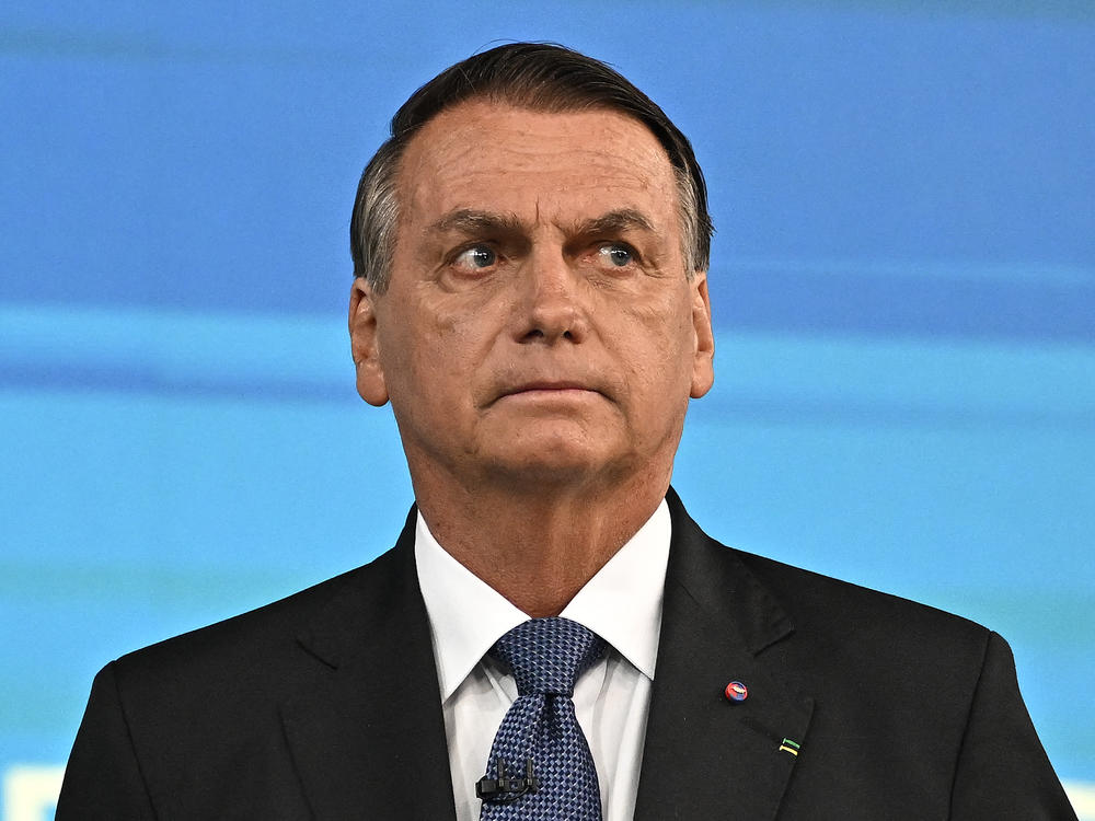 Former Brazilian President Jair Bolsonaro, pictured here at an election debate in October, left his country for Florida two days before his term ended.