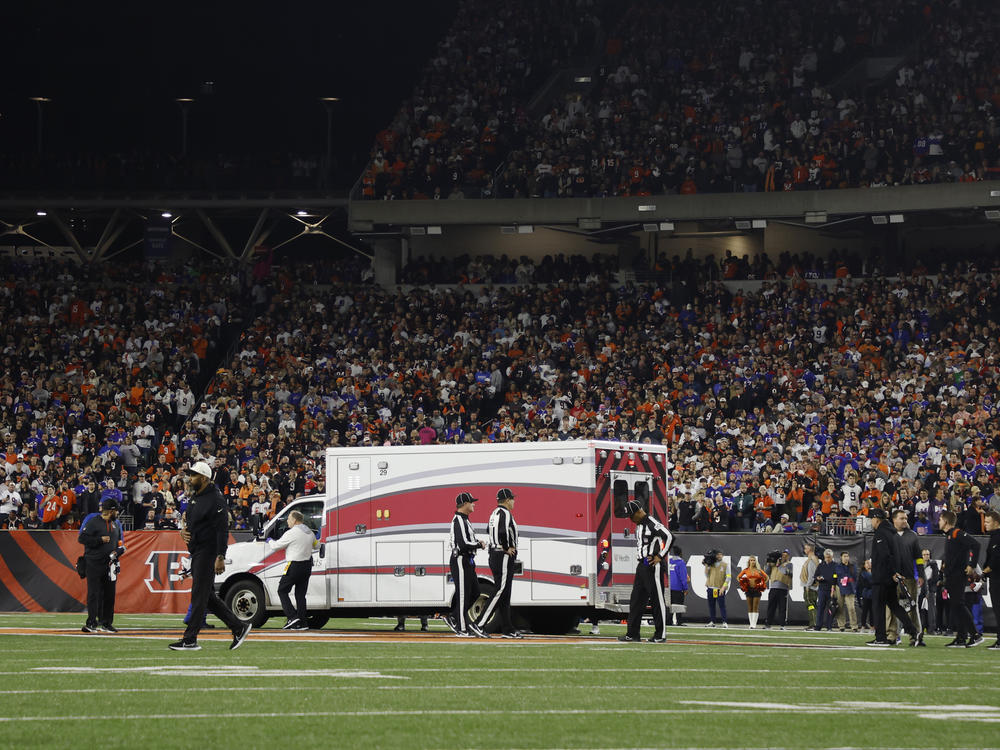 Fans look on as the ambulance leaves carrying Buffalo Bills player Damar Hamlin off the field on Jan. 2 after he collapsed after making a tackle against the Cincinnati Bengals.