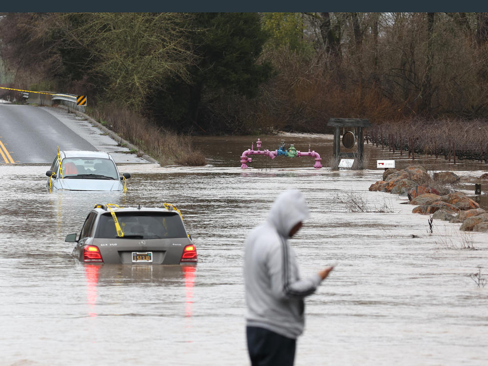 Cars are submerged in floodwater after heavy rain moved through the area on Monday in Windsor, California. The San Francisco Bay Area continues to get drenched by powerful atmospheric river events that have brought high winds and flooding rains.