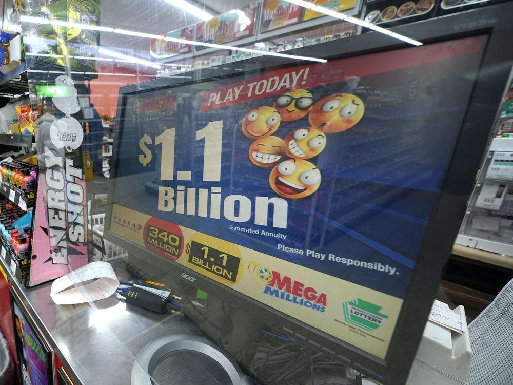 A Mega Millions customer purchases her tickets for the estimated jackpot of $1.1 Billion at the Fuel On Convenience Store in Pittsburgh, Monday, Jan. 9, 2023. Twenty-four consecutive drawings later with no grand prize winner named, the Mega Millions jackpot is now over $1 billion, making it one of the largest jackpots in lottery history. The next drawing is Friday.