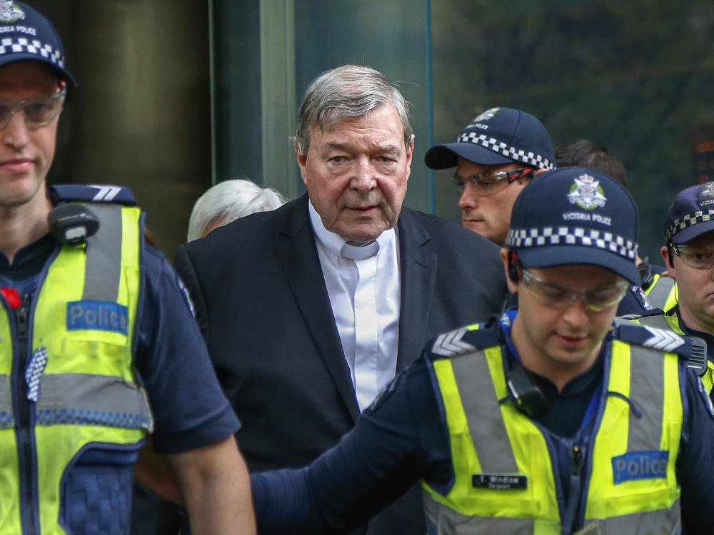 Cardinal George Pell, center, the most senior Catholic cleric to face sex charges, leaves court in Melbourne, Australia, May 2, 2018. Pell, who was the most senior Catholic cleric to be convicted of child sex abuse before his convictions were later overturned, died on Tuesday in Rome at age 81.