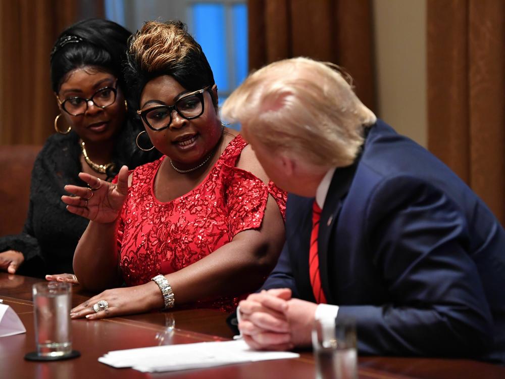 Then-president Donald Trump listens as Hardaway, left, and Richardson speak during a meeting in the White House Cabinet Room in February 2020.