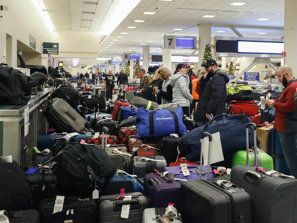 Stranded Southwest Airlines passengers look for their luggage in Chicago last month.