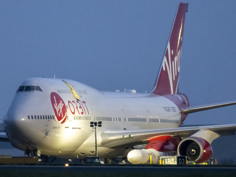 Cosmic Girl, a Boeing 747 modified to carry the LauncherOne rocket under its left wing, took off from the new Cornwall Spaceport in Newquay, U.K., Monday night. The craft is seen here hours before taking off.