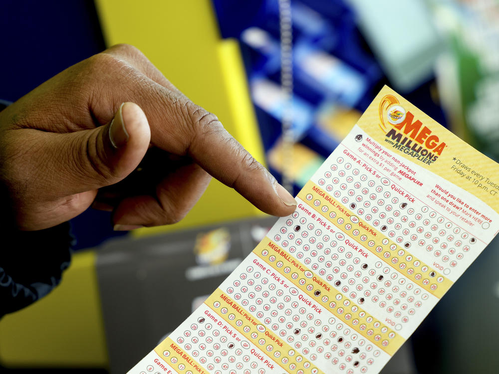 A Mega Millions lottery slip is displayed at Lucky Mart in Chicago on Tuesday, Jan. 10, 2023. After nearly three months of lottery losing, the Mega Millions jackpot has swelled above $1 billion. The odds of winning the top lottery prize are formidable at 1 in 302.6 million.