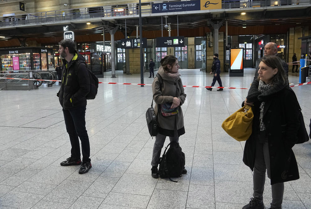 Travelers wait behind police tape at the Gare du Nord train station on Wednesday.