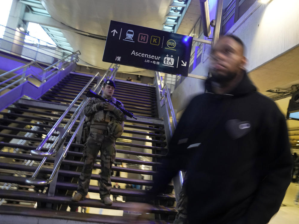 A soldier patrols at the Gare du Nord train station on Wednesday after an attacker stabbed 6 people before being shot by police.