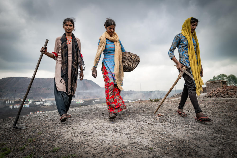 Suhani (15), Suman (21) and Anjali (16) depart from Ghansadih mine, Jharia in July 2022. They collect coal most mornings before attending classes at the local school and then going for arts instruction from the Coalfield Children Classes, a nonprofit organization.