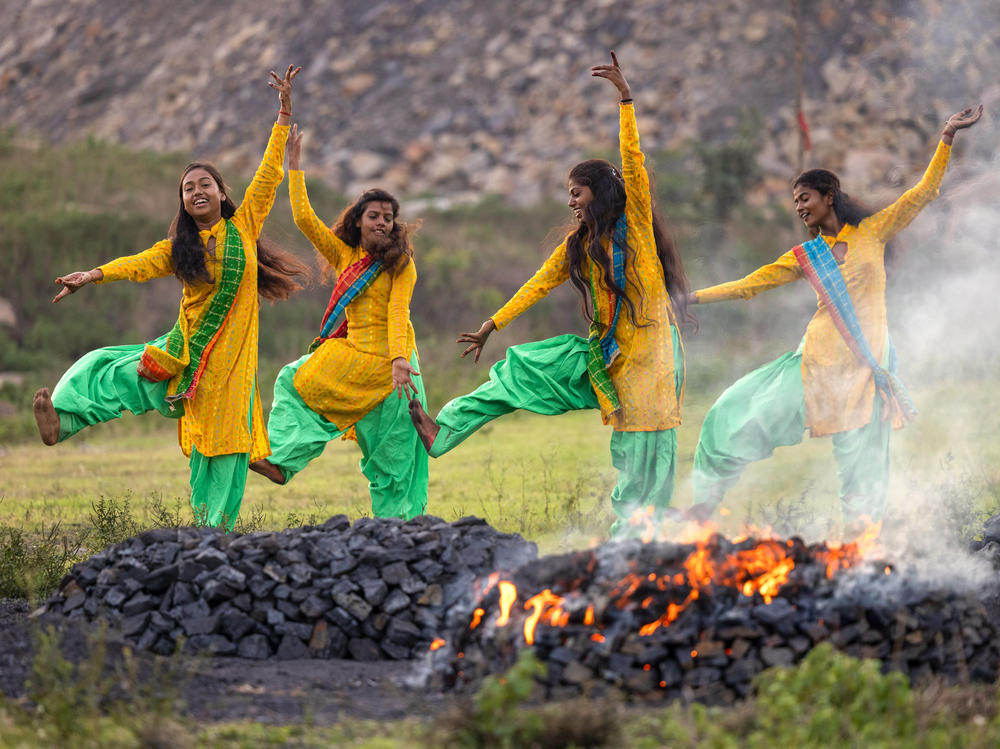 Radhika (15), Anjali (16), Suman (21), and Suhani (15) in July 2022 perform a dance routine near the village of Sahana Pahari, Jharia.