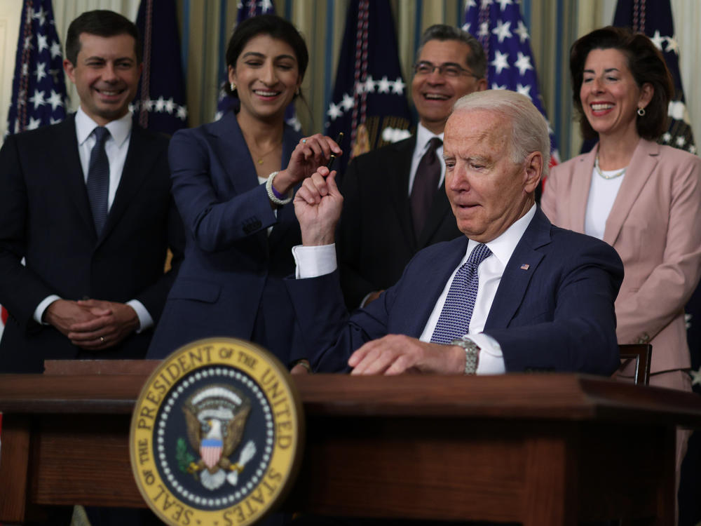 President Joe Biden passes a signing pen to Chair of the Federal Trade Commission Lina Khan on July 9, 2021, after signing an executive order promoting competition in the U.S. economy. Eighteen months later, the FTC followed  up on the executive order by proposing a rule banning noncompetes.