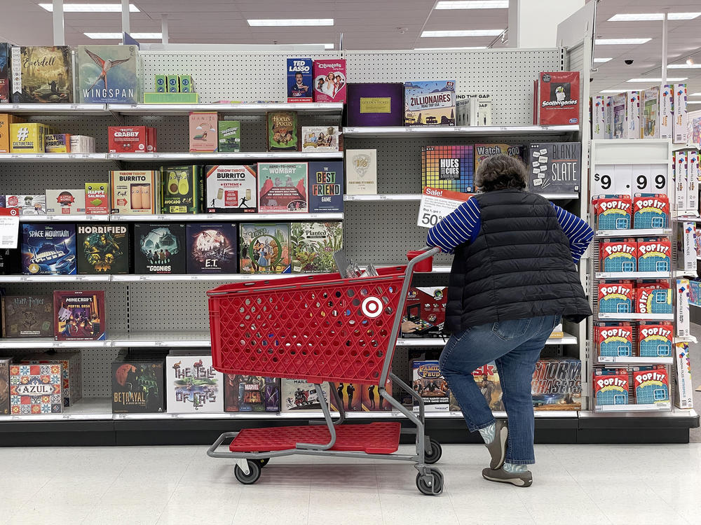 A Target customer looks at a display of board games while shopping at Target store in San Francisco, Calif. Inflation continues to ease, even if many people many not feel that way in their daily lives.