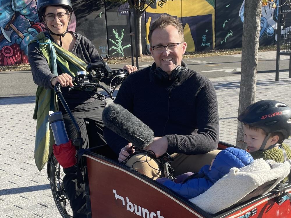 Lelac Almagor and two of her children take NPR's Adam Bearne for a ride in their e-cargo bike.