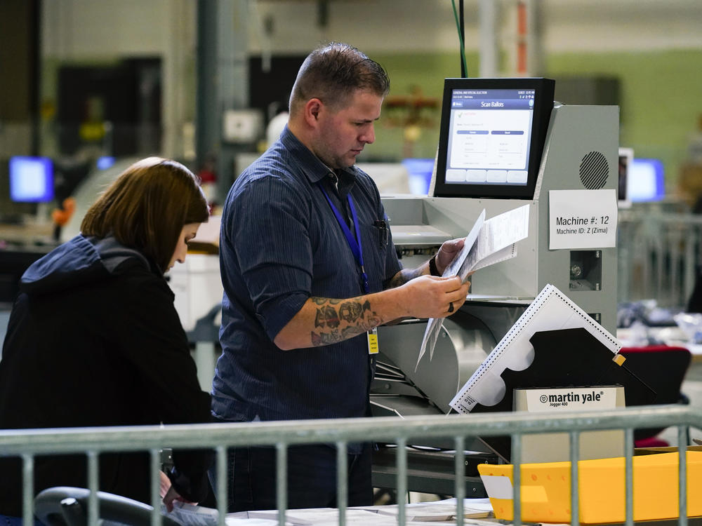 Election workers process mail ballots for the midterm elections in Philadelphia on Nov. 8, 2022.