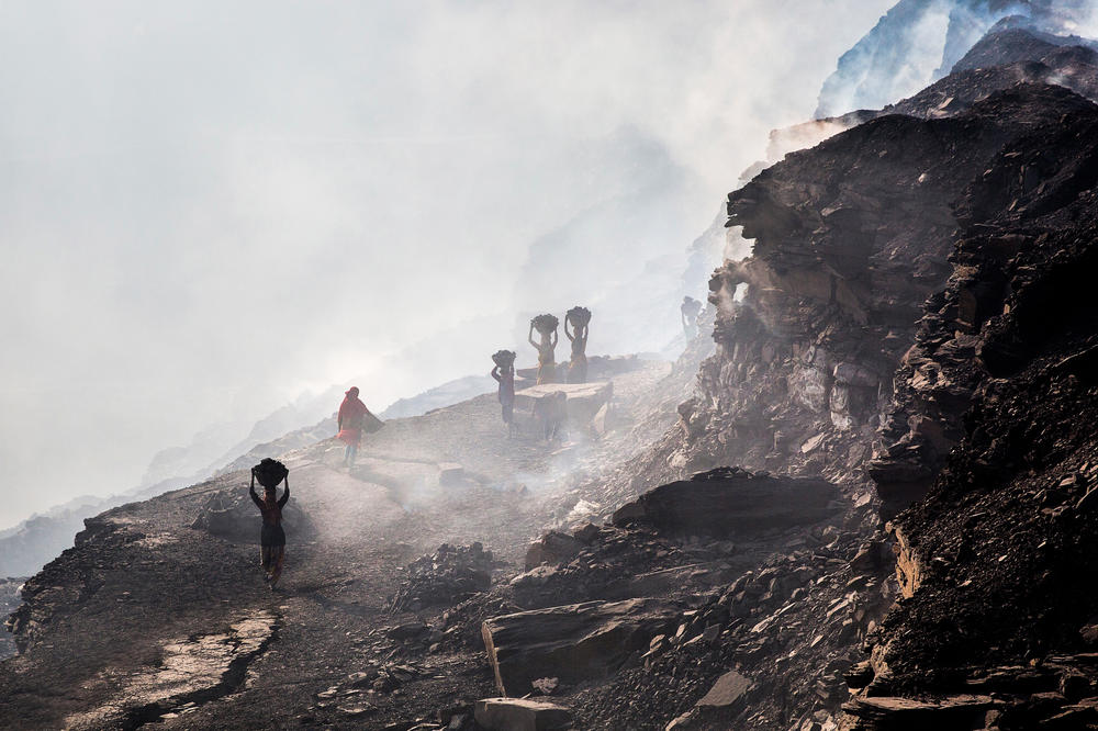 People young and old scavenge for coal in a mine in Jharia. They typically come with their baskets in the early morning to avoid detection by official coal workers.<strong> </strong>