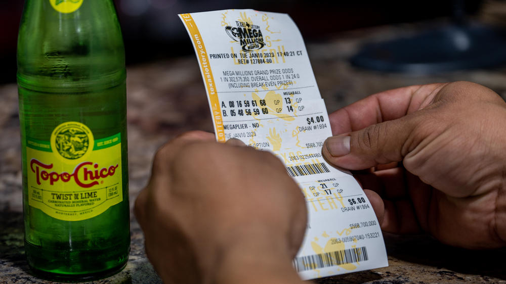 A customer looks at his lottery ticket at a CITGO gas station in Austin, Texas, on Jan. 10, as the Mega Millions jackpot climbed further above the $1 billion mark. The projected jackpot for Friday's drawing is $1.35 billion.