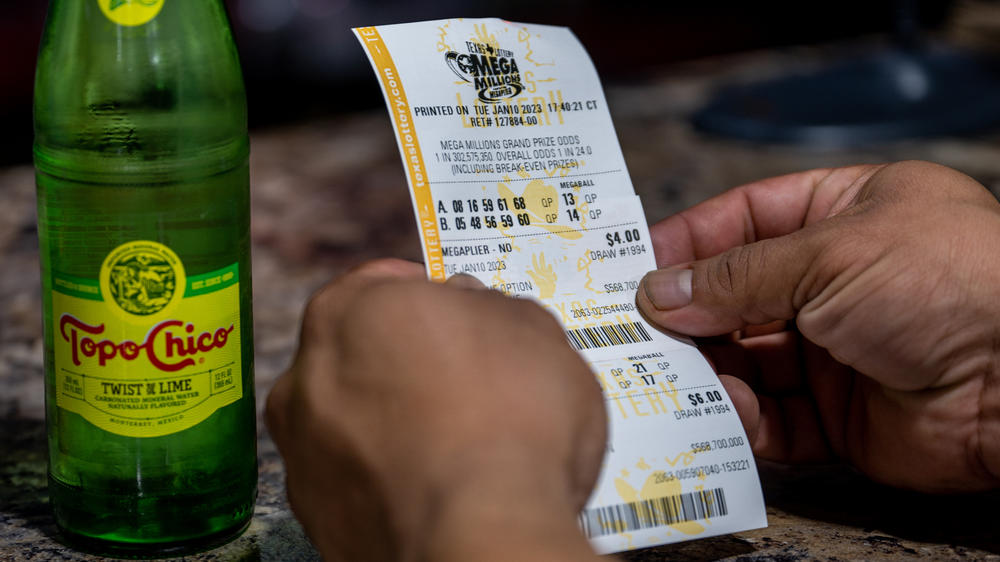 A customer looks at his lottery ticket at a CITGO gas station in Austin, Texas, on Jan. 10, as the Mega Millions jackpot climbed further above the $1 billion mark. The projected jackpot for Friday's drawing is $1.35 billion.