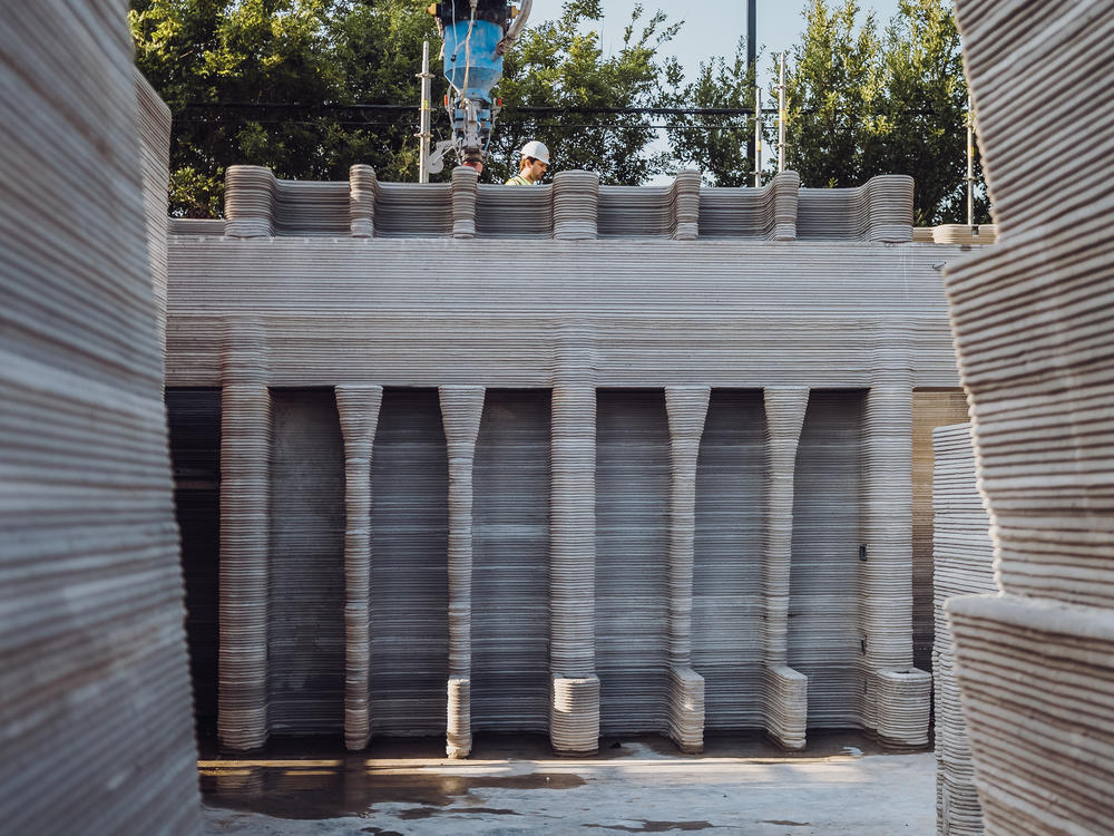The project's design puts automated construction to the test with complicated features, like built-in shelving.