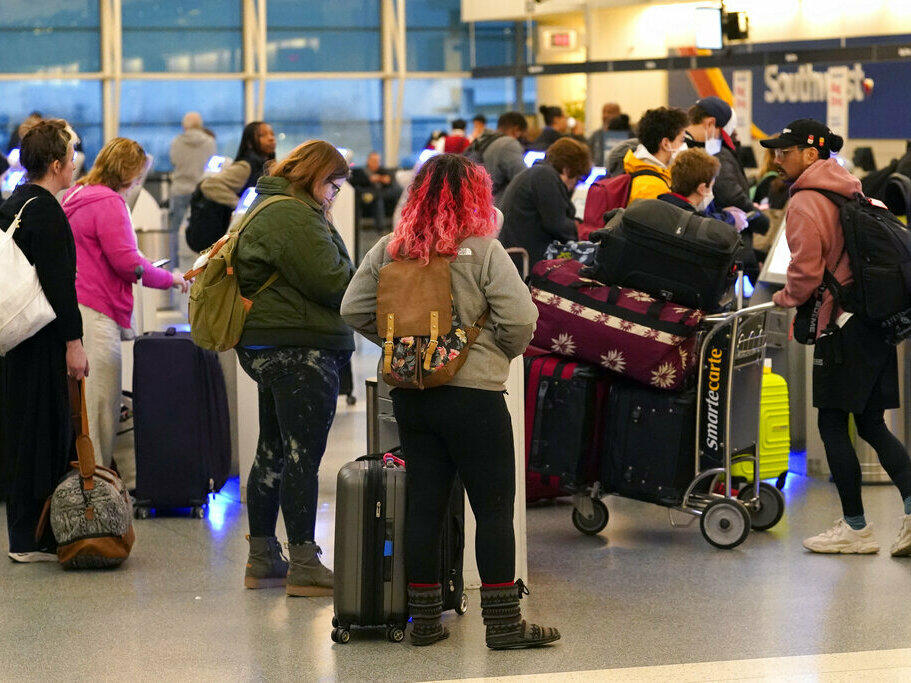 Passengers check in at Southwest Airlines' self-serve kiosks at Chicago's Midway Airport as delays stemming from a computer outage at the Federal Aviation Administration brought flights to a standstill across the U.S. on Wednesday.
