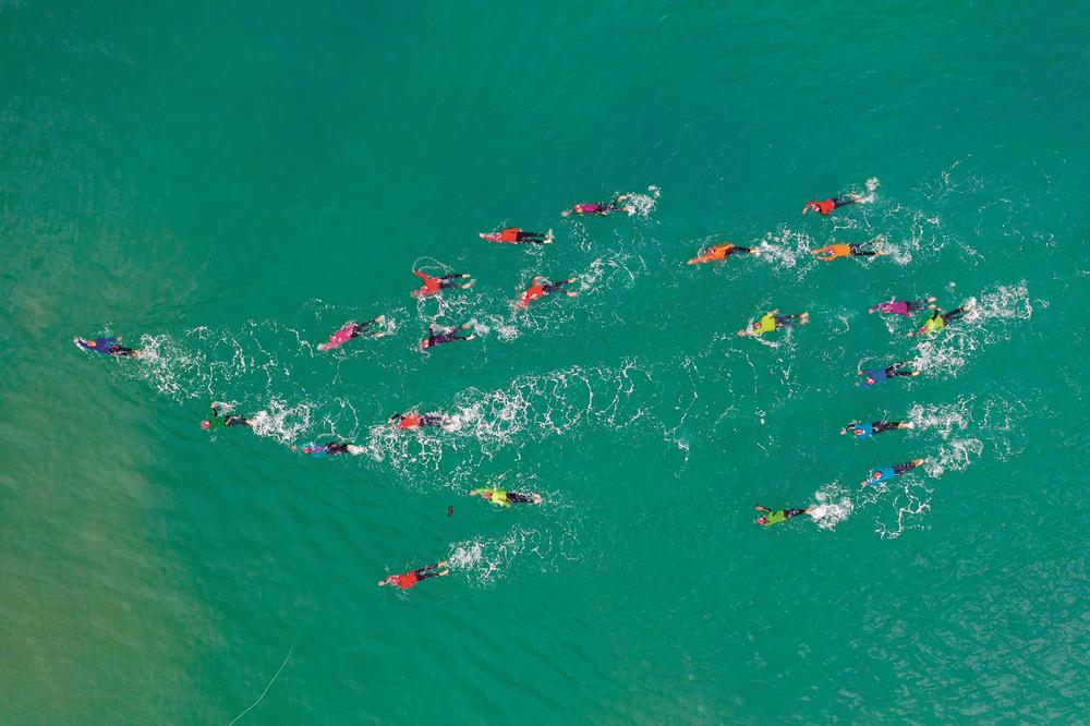 Las Truchas, an open-water women's swimming group formed in Peru during the height of the COVID-19 pandemic, is seen the the Pacific wearing colors of the rainbow to symbolize peace and love.