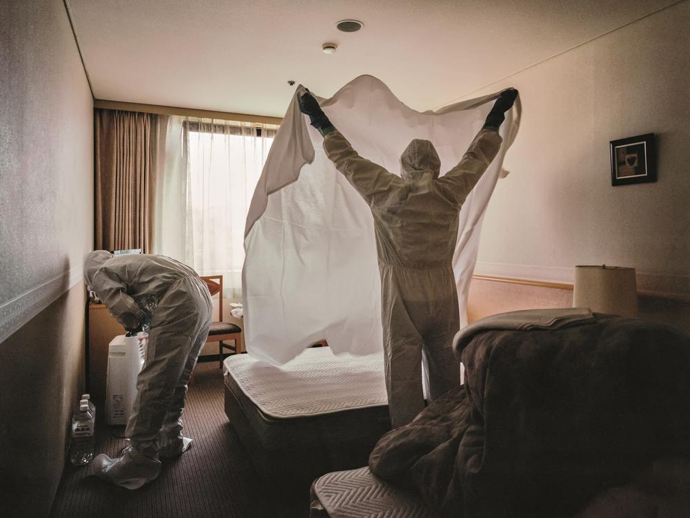 Medical staff in the Kansai region of Japan clean a hotel room that was used as a COVID-19 for asymptomatic and mildly symptomatic patients.