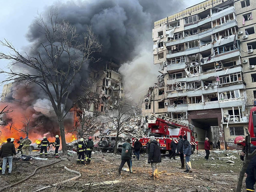 In this photo released by the Ukrainian Presidential Press Office, smoke rises after a Russian rocket hit a multistory building leaving many people under debris in Dnipro, Ukraine, on Saturday.