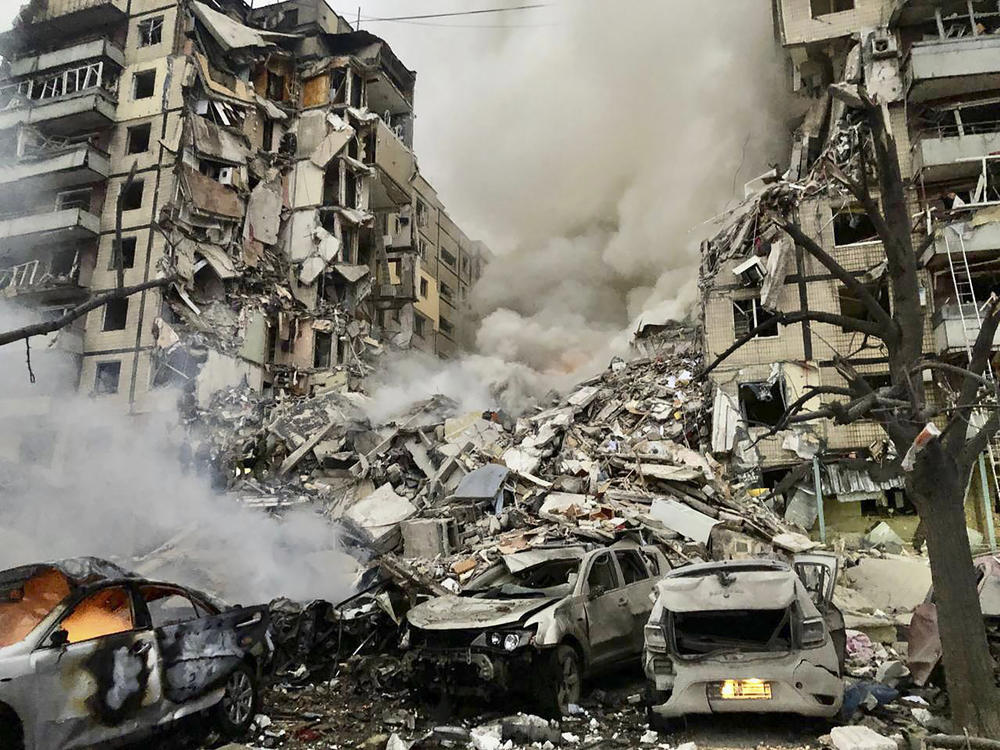 In this photo released by the Dnipro Regional Administration, smoke rises after a Russian rocket hit a multistory building leaving many people under debris in Dnipro, Ukraine, on Saturday.