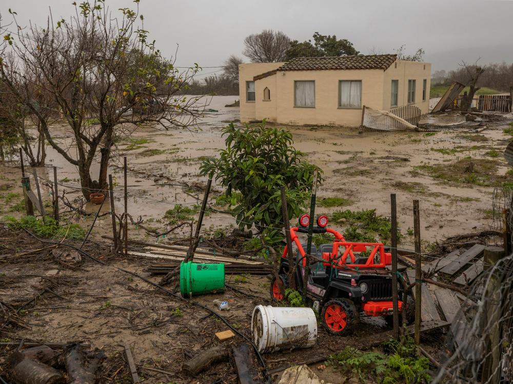 Flood waters inundate a home by the Salinas River near Chualar, Calif., on Saturday. A series of atmospheric river storms continue to cause widespread destruction across the state.