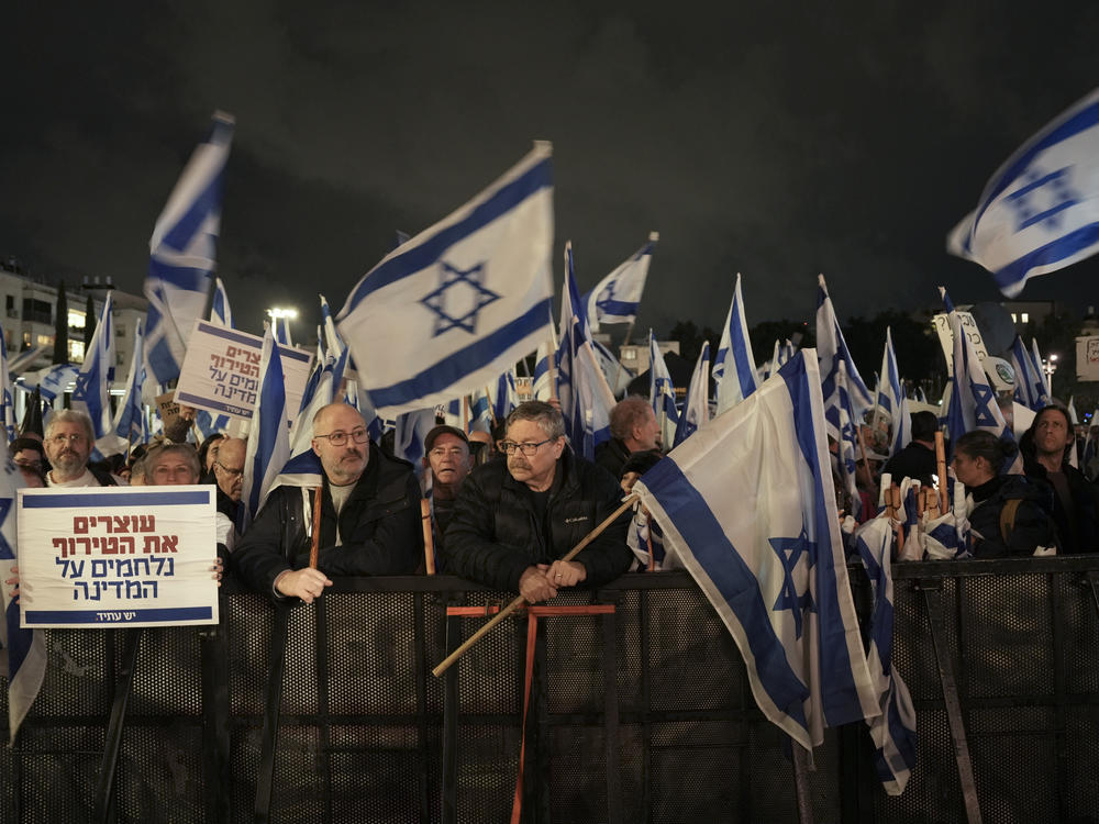 Israelis protest against the government's plans to overhaul the country's legal system, in Tel Aviv, Israel, Saturday, Jan. 14, 2023. The new government unveiled its plan this month proposing changes that critics say will weaken the country's judiciary and imperil its democratic system of checks and balances.