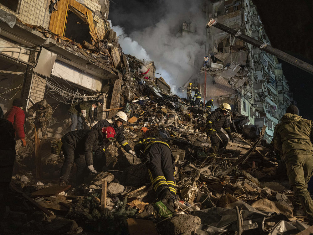 In Dnipro, workers used a crane as they tried to rescue people trapped on upper floors of the apartment tower where about 1,700 were living.