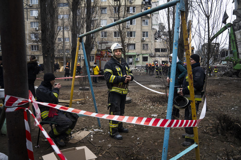 Serhii Shova (center) is a squad commander of an emergency crew that has been working at the site since Saturday.