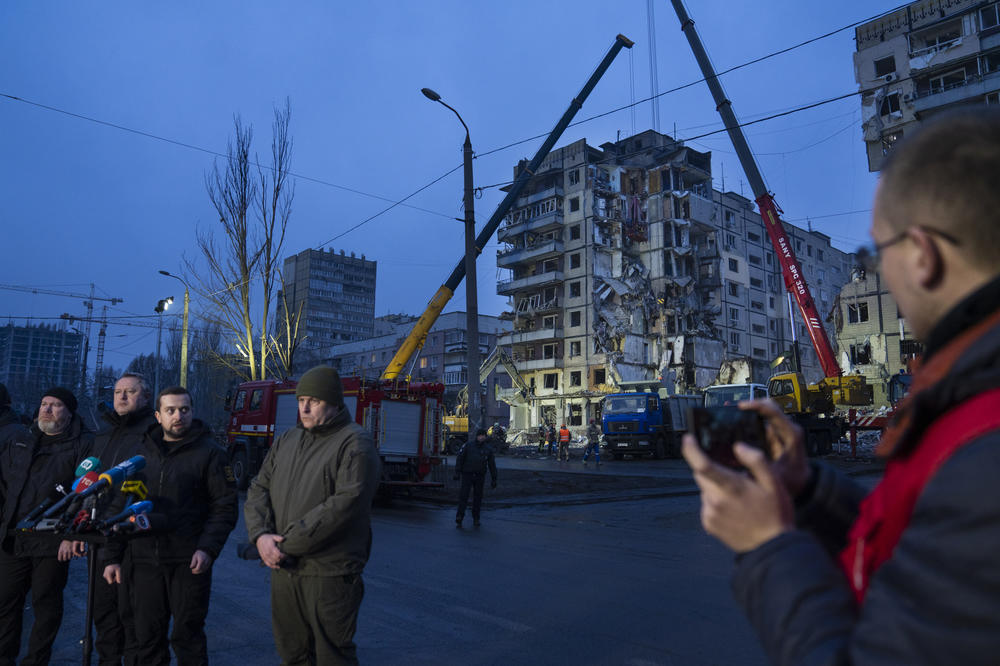 Kyrylo Tymoshenko, Deputy Head of the Office of the President of Ukraine, speaks in front of the damaged apartment building on Monday.