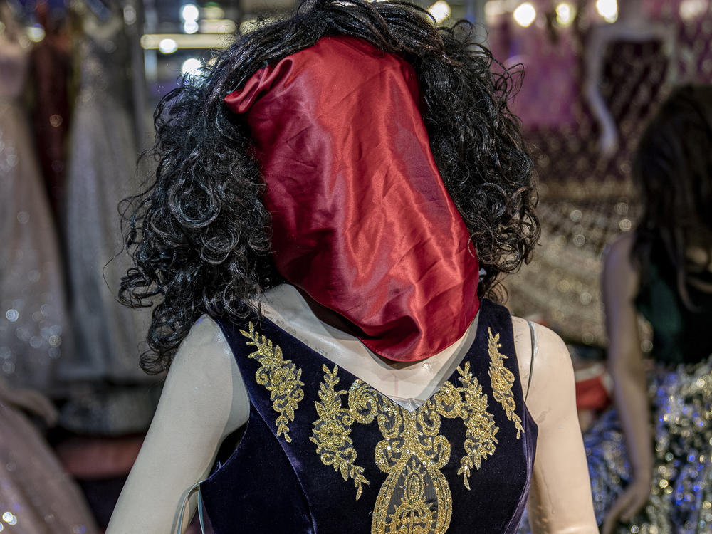 A mannequin's head is covered in a woman dress shop in Kabul, Afghanistan, Monday, Dec. 26, 2022.