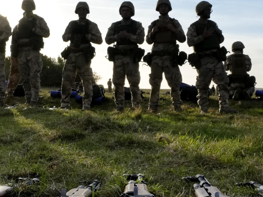 FILE - Weapons lie on the ground as Ukrainian personnel train at a base in Southern England. The U.S. military's new, expanded combat training of Ukrainian forces began in Germany on Sunday, Jan. 15th.