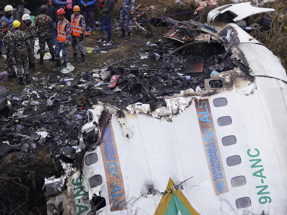 Rescuers scour the crash site and wreckage of a passenger plane in Pokhara, Nepal, Monday, Jan.16, 2023. Nepal began a national day of mourning Monday a day after the plane crashed while attempting to land.