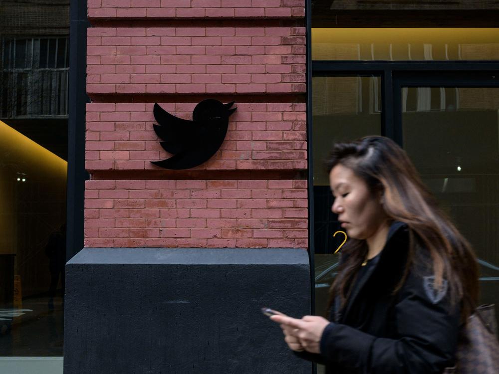 A person walks past the Twitter offices in New York City last week. Lawyers for Musk argued that public perception of the billionaire's Twitter takeover has tainted the potential jury pool.