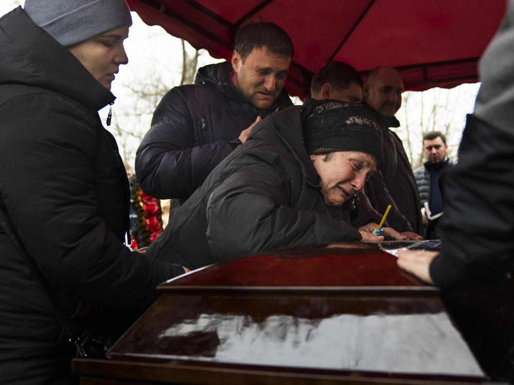 Korenovsky's mother cries over her son's coffin at his funeral on Tuesday.