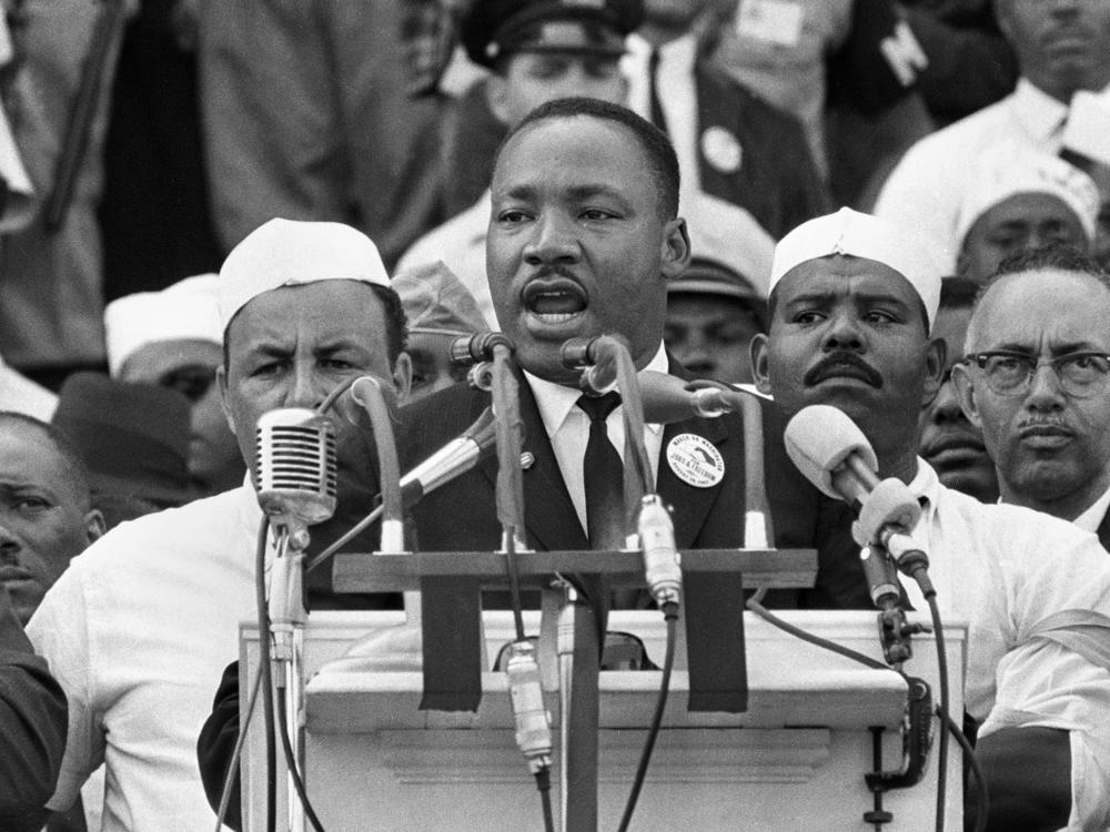 Dr. Martin Luther King Jr., head of the Southern Christian Leadership Conference, addresses marchers during his 