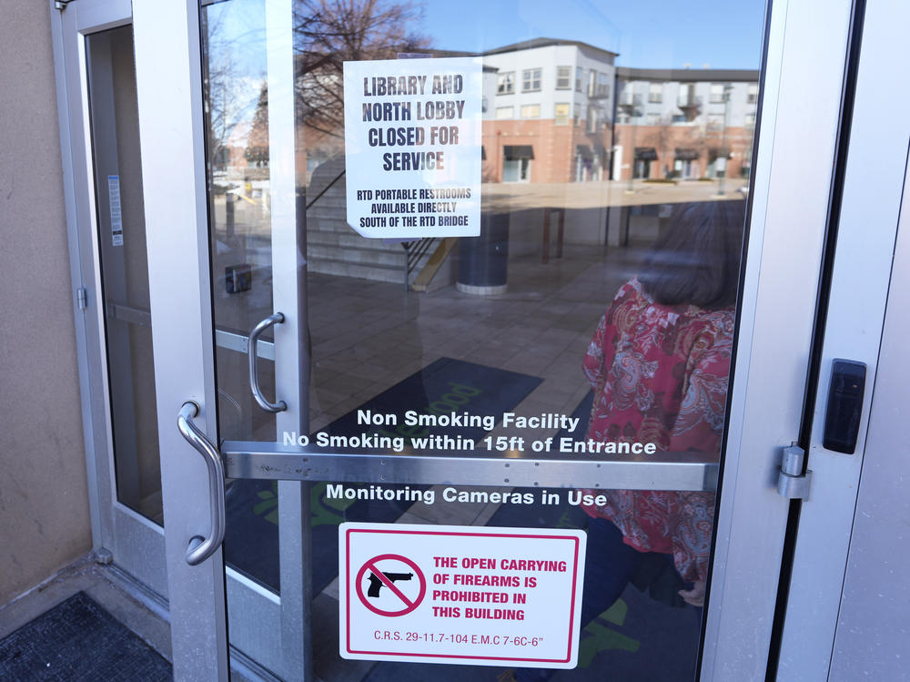 Signs are placed on the outside doors of city hall to advise visitors that the library as well as a restroom are closed because of meth contamination in the south Denver suburb of Englewood, Colo.