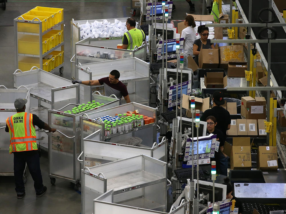 Workers pack orders at an Amazon fulfillment center on January 20, 2015 in Tracy, California. OSHA cited Amazon after federal safety inspectors found ergonomic hazards at three Amazon warehouses.