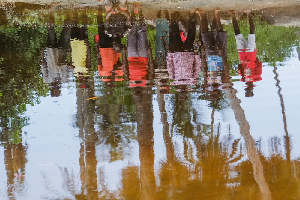 Residents of Barconie stand over their sacred lagoon after a ceremony on Nov. 16, 2022.