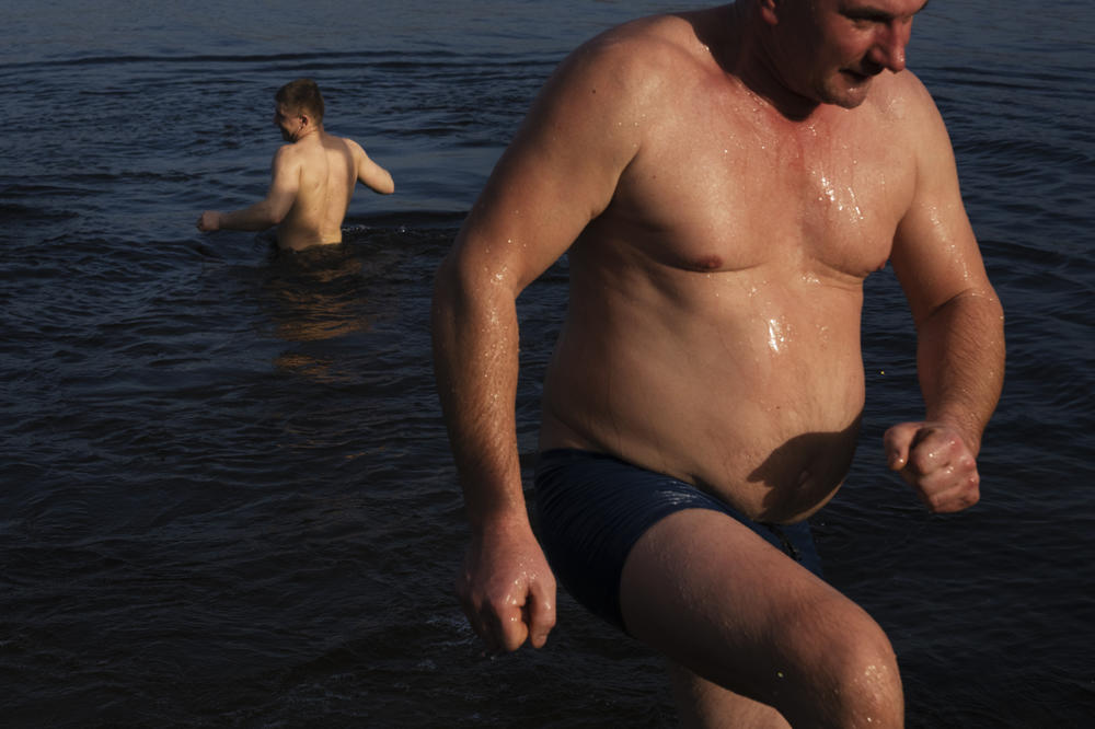 Men take turns going in and out of the river for much of the morning on Thursday.