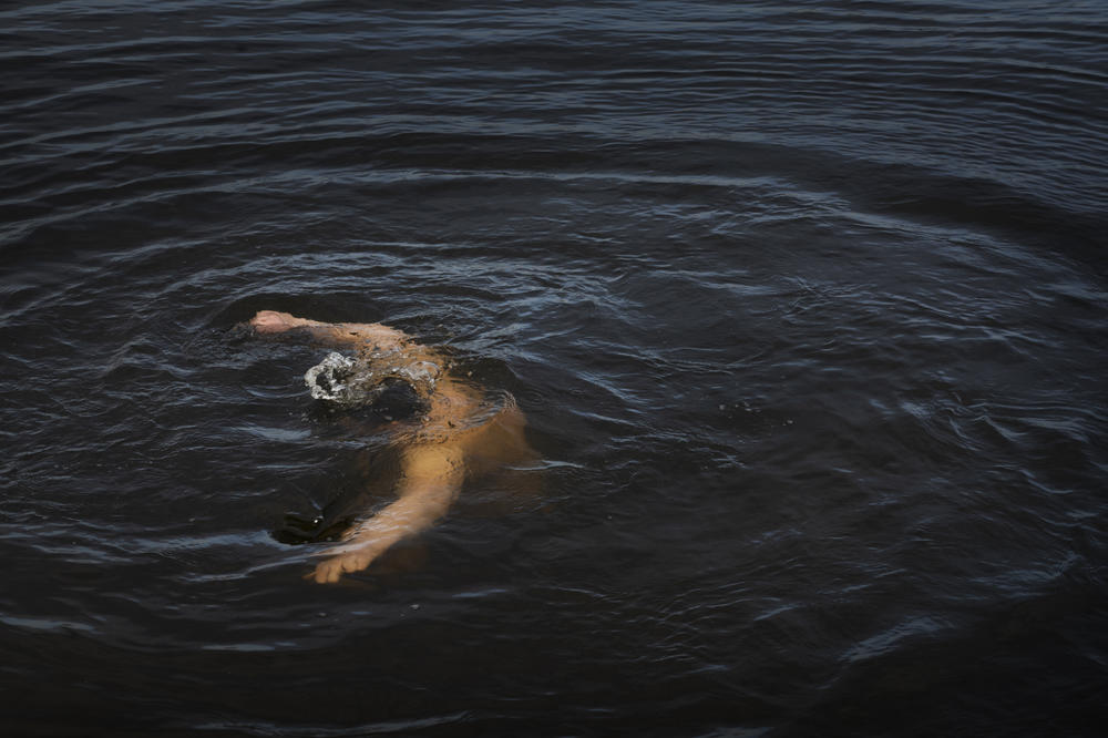 A man dunks under the water on Thursday in Dnipro.