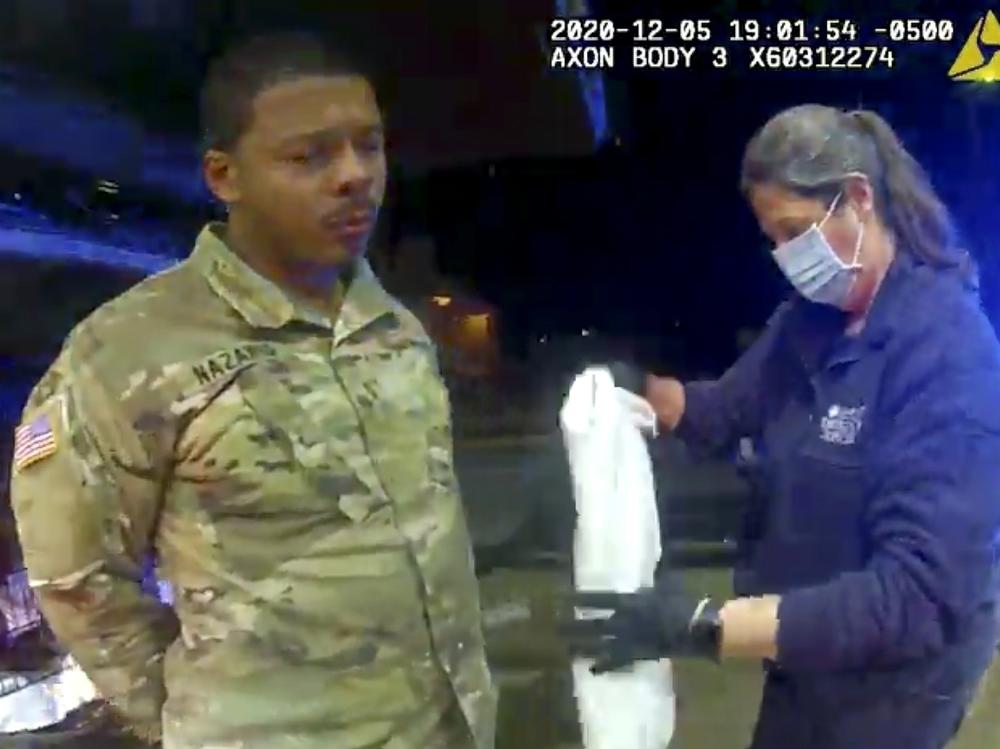 In this image taken from Windsor, Va., police body camera footage, Lt. Caron Nazario is helped by an EMT after he was pepper-sprayed by Windsor police during a traffic stop in Windsor, on Dec. 20, 2020.