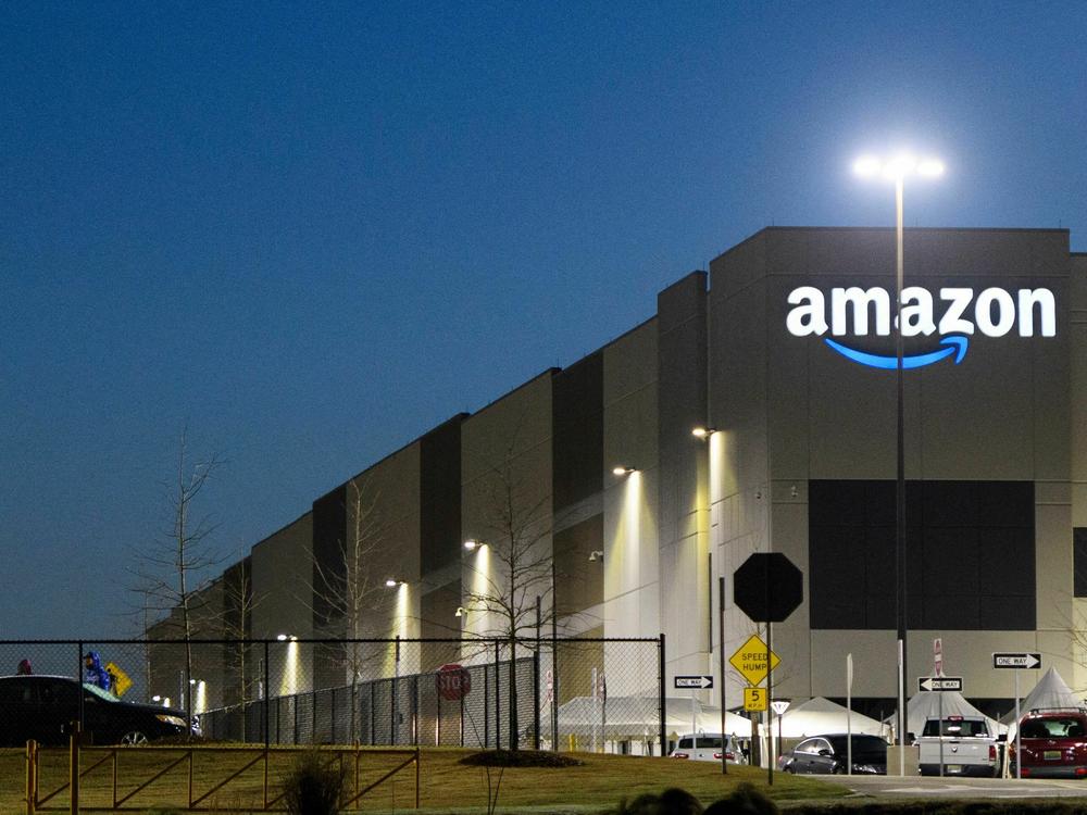 An Amazon fulfillment center is seen before sunrise on March 29, 2021, in Bessemer, Ala. Amazon announced it is ending its charity donation program, AmazonSmile.