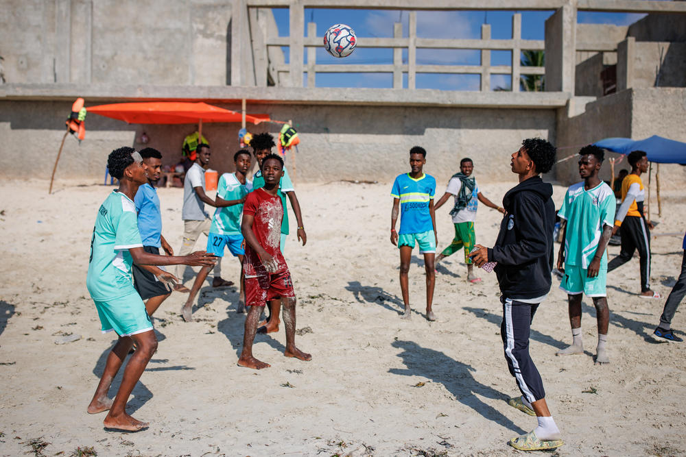 A group of young men kick around a soccer ball on the sand at Liido Beach in Mogadishu, Somalia. Residents of the Somali capital flock to the beach on Fridays, the first day of the weekend.