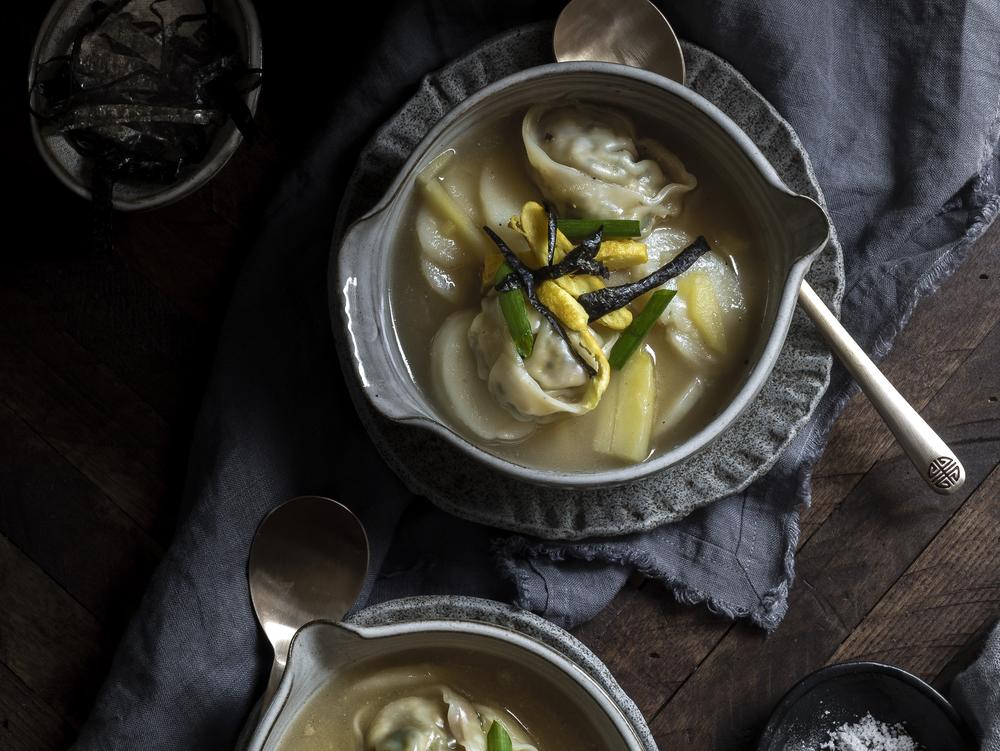 Tteokguk, a Korean rice cake soup, is made from a broth that simmers for hours and soft tteok, rice cakes, representing the purity of a clean slate.