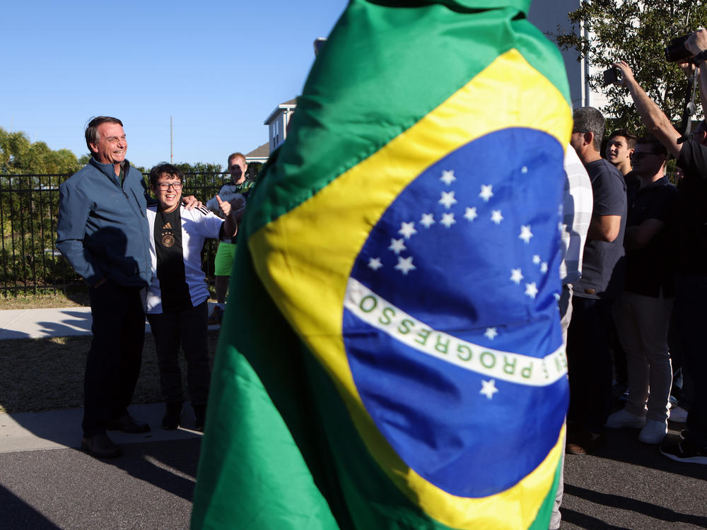 Former President of Brazil Jair Bolsonaro greets supporters on Jan. 17, 2023, outside of a home where he has been staying in Kissimmee, Fla.