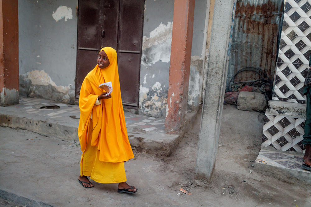 A schoolgirl walks along a street in Mogadishu.