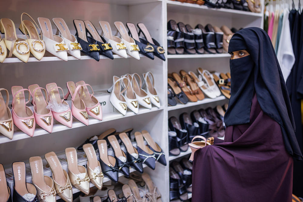 A woman shops for shoes at a clothing store in the Mogadishu Mall.